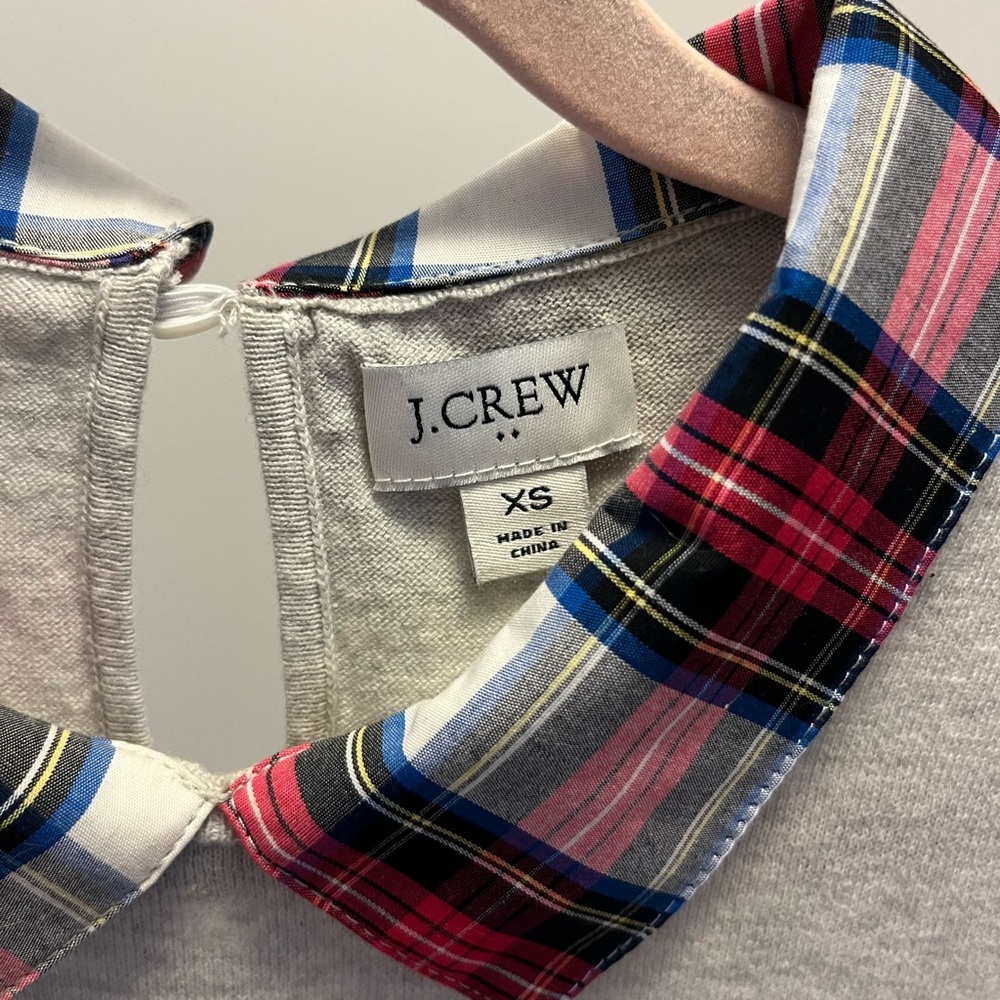 Jcrew light gray sweater with woven plaid collar, and shirt tail.